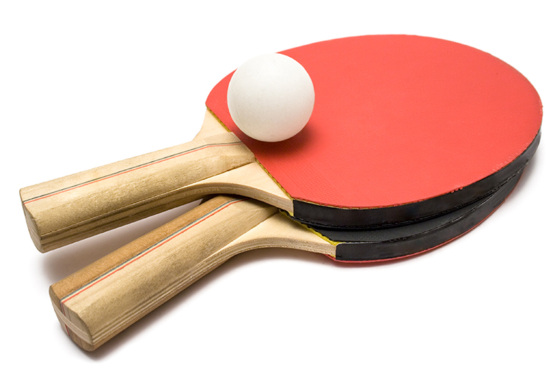 Two ping pong paddles with ball isolated on white.